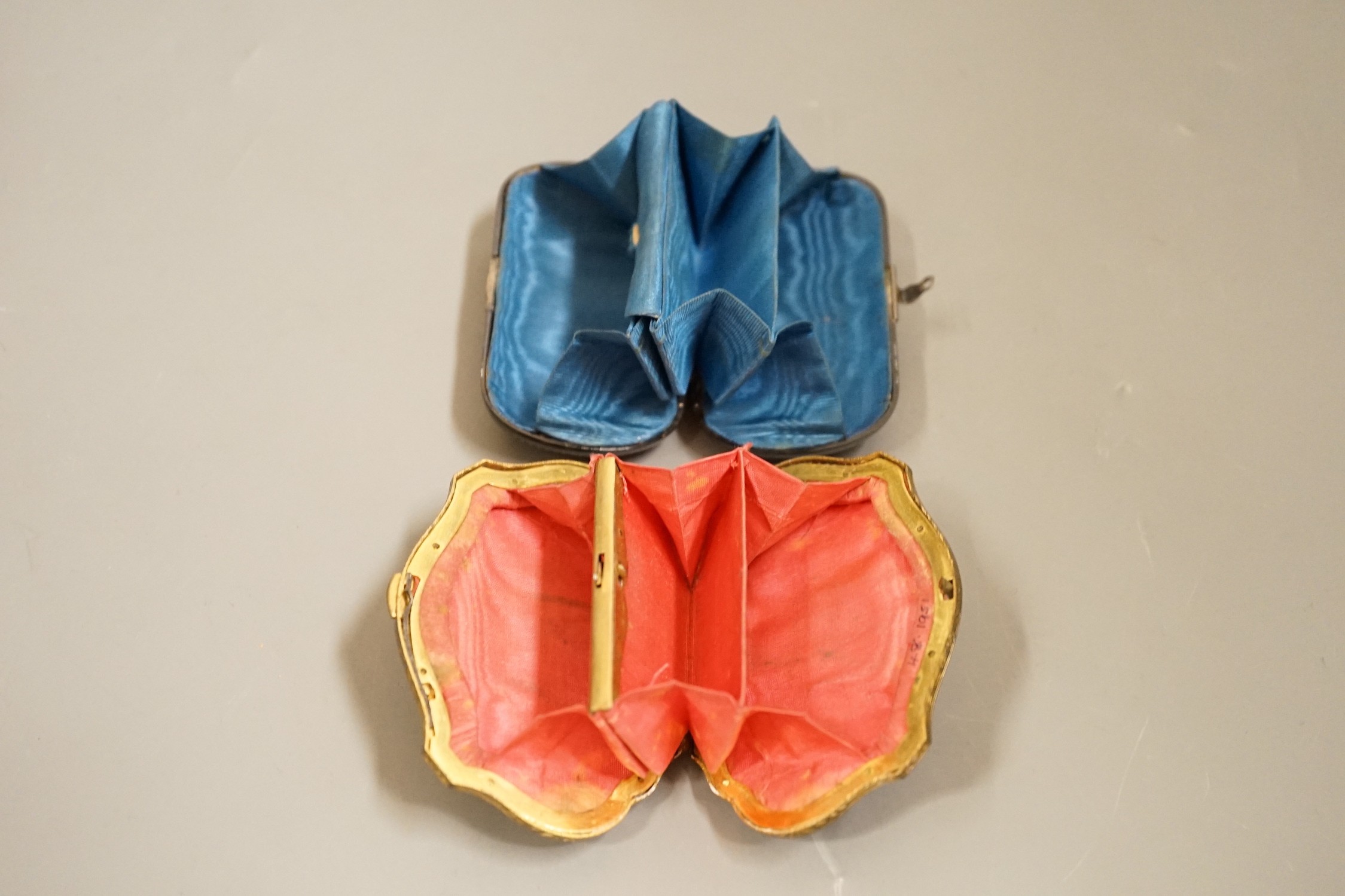 A 19th century finely worked tortoiseshell piqué work purse, with blue silk lining and a similar git metal edged piqué work purse